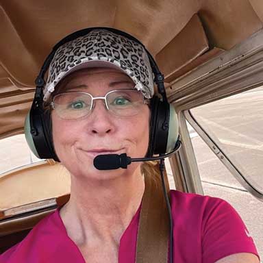 Dr. Baysinger piloting a small aircraft