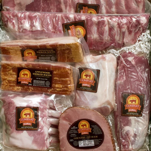 Assortment of fresh pork meat, including ribs, ham, bacon, loin