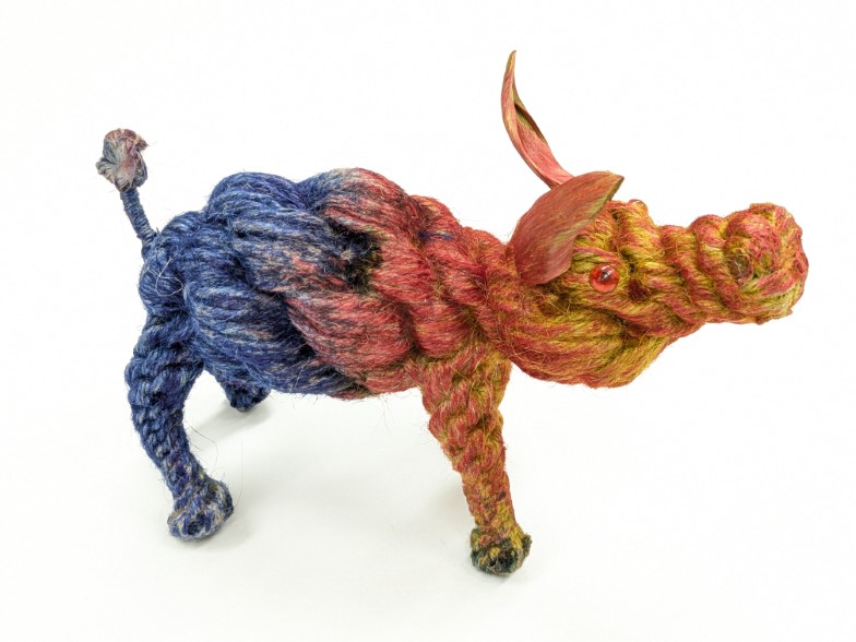 Artsy orange and purple pig crafted from jute twine